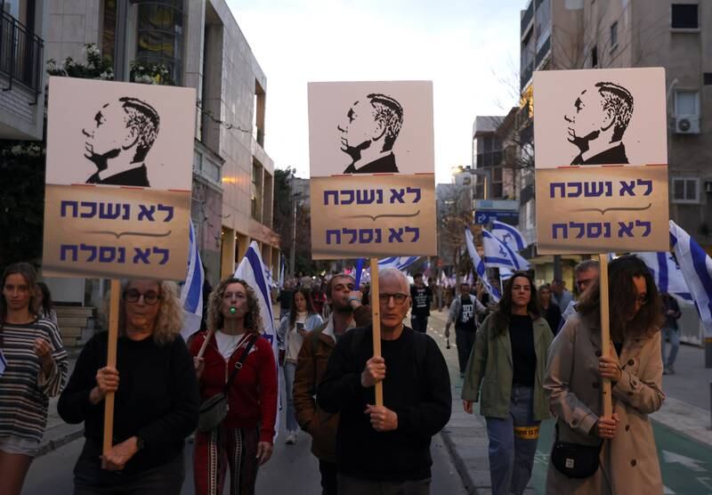 Protesters with placards of Prime Minister Netanyahu saying 'We will not forget, we will not forgive'. EPA