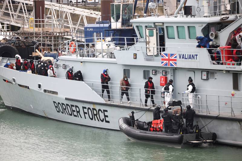 Migrants on board a Border Force rescue boat line up to disembark at Dover harbour after crossing the Channel. Reuters