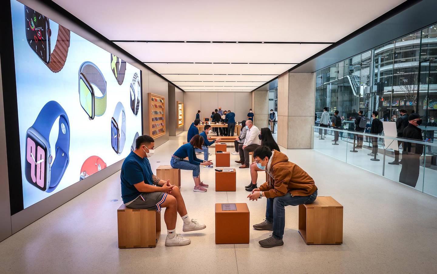 Employees wear protective masks while serving customers at the Apple Inc. flagship store in Sydney, Australia, on Friday, Sept. 18, 2020. Apple's annual Fall product blitz included new Apple Watches and an upgraded iPad Air. Later this year, the company is expected to unveil several new 5G iPhones. Photographer: David Gray/Bloomberg
