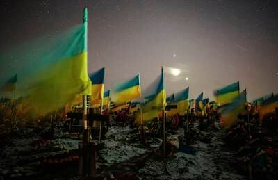 Ukrainian flags placed over the graves of fallen Ukrainian soldiers in a military cemetery in Kharkiv, north-eastern Ukraine. EPA