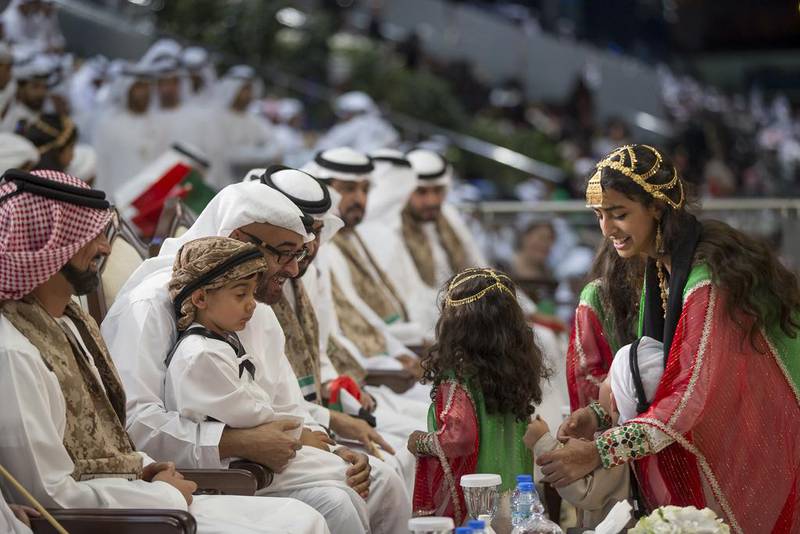 Sheikh Ammar bin Humaid Al Nuaimi, Crown Prince of Ajman, left, Sheikh Tahnoon bin Mohamed bin Tahnoon, second left, and Sheikh Mohammed bin Zayed, Crown Prince of Abu Dhabi and Deputy Supreme Commander of the UAE Armed Forces, third left, at National Day celebrations at the Abu Dhabi National Exhibition Centre with Sheikha Hessa bint Mohammed bin Hamad bin Tahnoon, right. Mohamed Al Hammadi / Crown Prince Court - Abu Dhabi