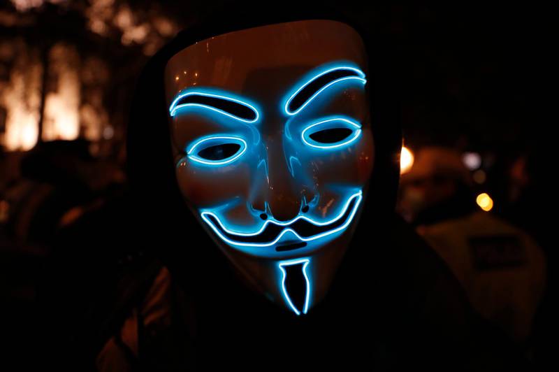 A participant in 'The Million Mask March', an annual event described as a march "against austerity, the infringement of rights, war crimes, corrupt politicians and to reinstate liberty", gathers in central London. AP Photo