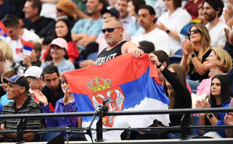 Supporters of Novak Djokovic hold up a Serbia flag. Getty Images