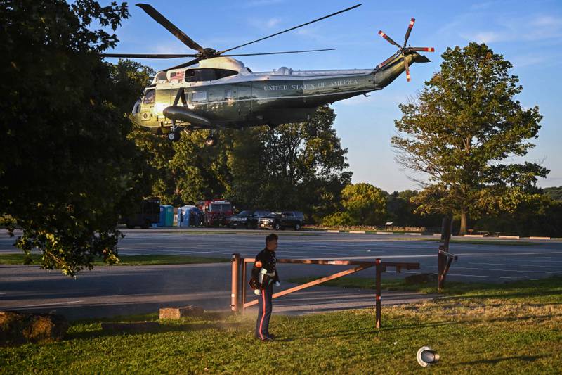 A US Marine's hat is blown off as US President Joe Biden takes off from Brandywine Creek State Park in Wilmington, Delaware. AFP