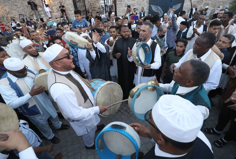 Libyans gather around a troupe at the Bab al-Jadid gate in the old city of the capital Tripoli, as they celebrate the third day of Eid al-Fitr, which marks the end of the holy fasting month of Ramadan. AFP