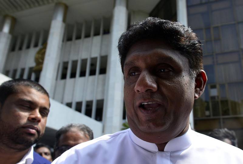 Sri Lankan legislator Sajith Premadasa (R) walks out from the Supreme Court after filing a petition against President Maithripala Sirisena’s sacking of the legislature, in Colombo on November 12, 2018. Supporters of Sri Lanka's fired prime minister and a top election official on November 12 challenged in court the president's sacking of parliament, upping the ante in a political crisis that has sparked international alarm.
 / AFP / LAKRUWAN WANNIARACHCHI
