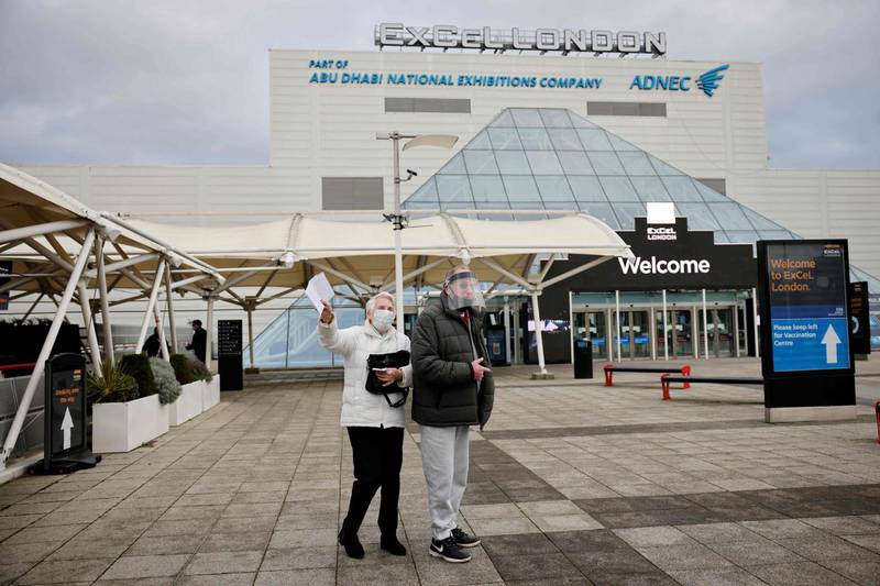 A couple pose for the press as they arrive at the Excel Centre as it opens as a mass vaccination centre in London. AFP