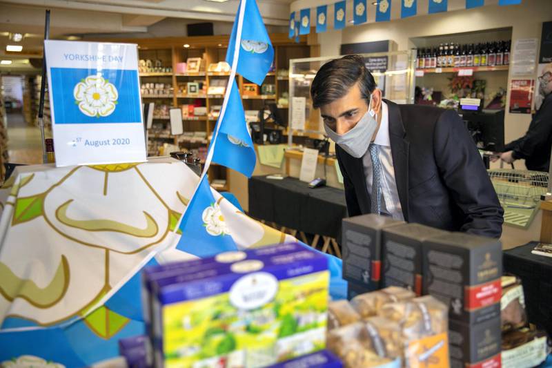 Rishi Sunak visits a local store as he helps advertise Eat Out To Help Out by putting up stickers in participating restaurants and cafes in Northallerton in July. HM Treasury