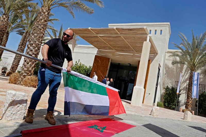 The flags of the nations taking part in the Negev Summit are set up outside the Kedma Hotel. AFP
