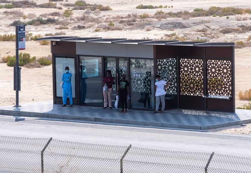 Commuters wait for their bus on a sunny and humid day in Al Shahama, Abu Dhabi. 