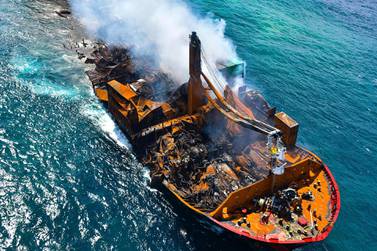 This handout photograph taken and released by Sri Lanka Air Force on June 2, 2021 shows smoke billowing from the Singapore-registered container ship MV X-Press Pearl which carrys hundreds of containers of chemicals and plastics, as its towed away from the coast of Colombo, following Sri Lankan President Gotabaya Rajapaksa's order to move the ship to deeper water to prevent a bigger enviromental disaster. - RESTRICTED TO EDITORIAL USE - MANDATORY CREDIT "AFP PHOTO /Sri Lanka Air Force " - NO MARKETING - NO ADVERTISING CAMPAIGNS - DISTRIBUTED AS A SERVICE TO CLIENTS / AFP / Sri Lanka Air Force / - / RESTRICTED TO EDITORIAL USE - MANDATORY CREDIT "AFP PHOTO /Sri Lanka Air Force " - NO MARKETING - NO ADVERTISING CAMPAIGNS - DISTRIBUTED AS A SERVICE TO CLIENTS