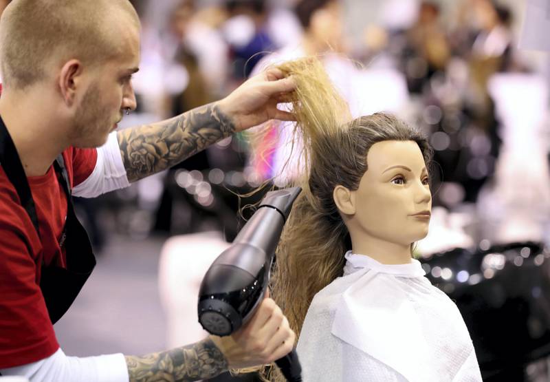 Abu Dhabi, United Arab Emirates - October 15th, 2017: People compete in the Hairdressing category at day 1 of World Skills 2017. Young people from 77 countries will come together and compete in 51 different skills competitions. Sunday, October 15th, 2017 at Abu Dhabi National Exhibition Center, Abu Dhabi. Chris Whiteoak / The National