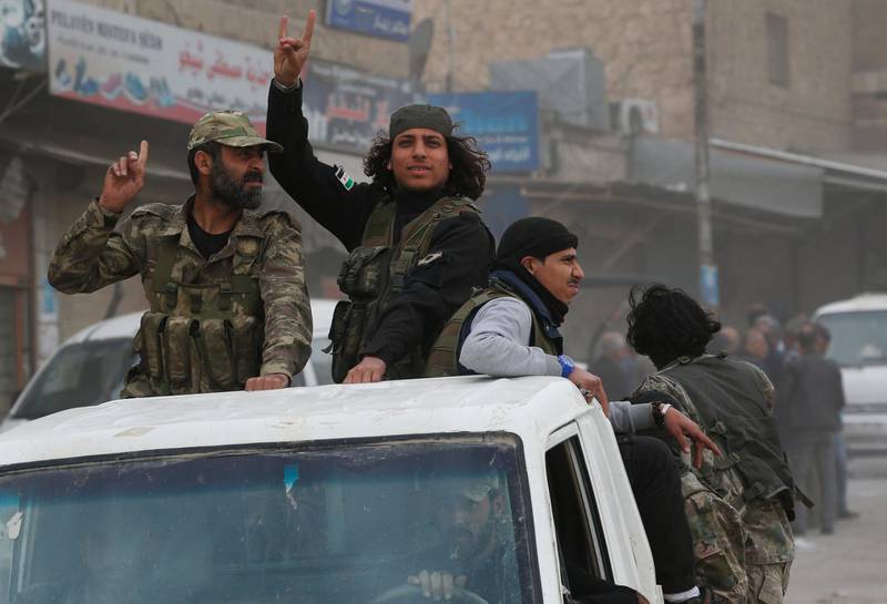 Turkey-backed opposition fighters of the Free Syrian Army patrol the northwestern city of Afrin, Syria, during a Turkish government-organised media tour into northern Syria, Saturday, March 24, 2018. Turkey and allied Syrian opposition fighters captured the city of Afrin on Sunday, March 18, nearly two months after the launch of an operation to clear the area of Syrian Kurdish forces. (AP Photo/Lefteris Pitarakis)