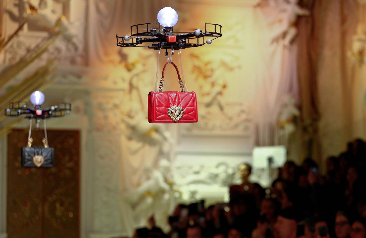 Drones carry bags, the creations from the Dolce & Gabbana Autumn/Winter 2018 women's collection during Milan Fashion Week in Milan, Italy February 25, 2018.  REUTERS/Alessandro Garofalo