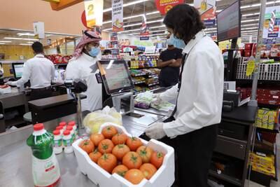 People wearing protective face masks and gloves shop at a supermarket, following the outbreak of the coronavirus disease (COVID-19), in Riyadh, Saudi Arabia May 11, 2020. REUTERS/Ahmed Yosri