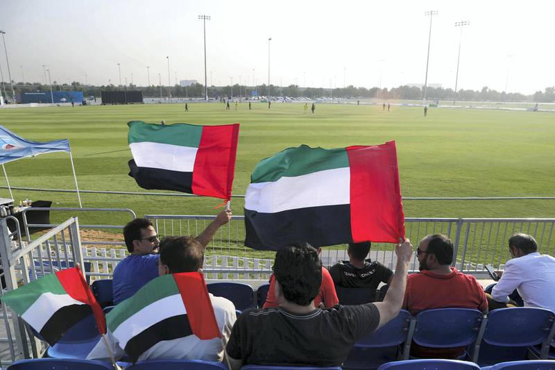 Abu Dhabi, United Arab Emirates - October 22, 2018: UAE fans wave their flags in the match between the UAE and Australia in a T20 international. Monday, October 22nd, 2018 at Zayed cricket stadium oval, Abu Dhabi. Chris Whiteoak / The National
