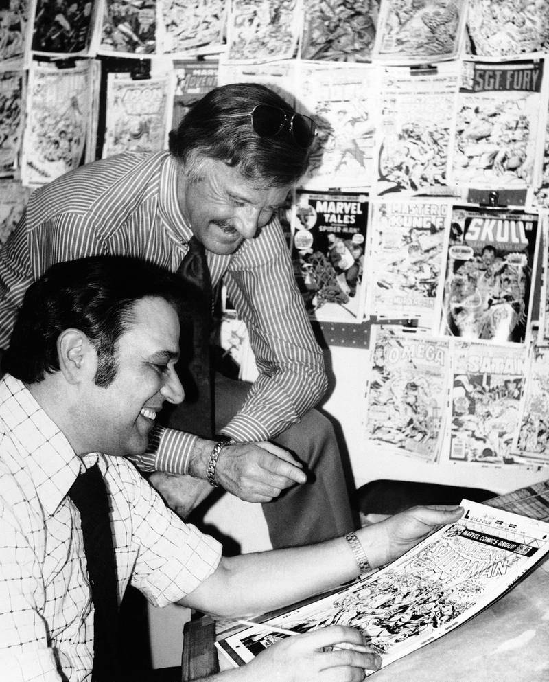 Stan Lee discusses a "Spiderman" comic book cover with artist John Romita at Marvel headquarters in New York., in 1976. AP Photo