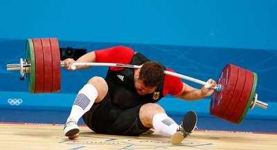 Germany's Matthias Steiner is injured while his weights fall during the men's +105kg Group A snatch weightlifting competition at the ExCel venue during the London 2012 Olympic Games August 7, 2012.      REUTERS/Grigory Dukor (BRITAIN  - Tags: OLYMPICS SPORT WEIGHTLIFTING)  