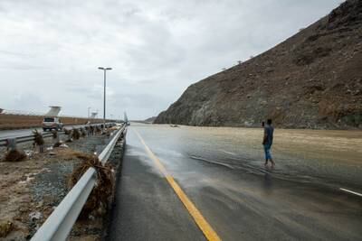 A man takes a photo of the floods in Fujairah. Issa Alkindy/The National
