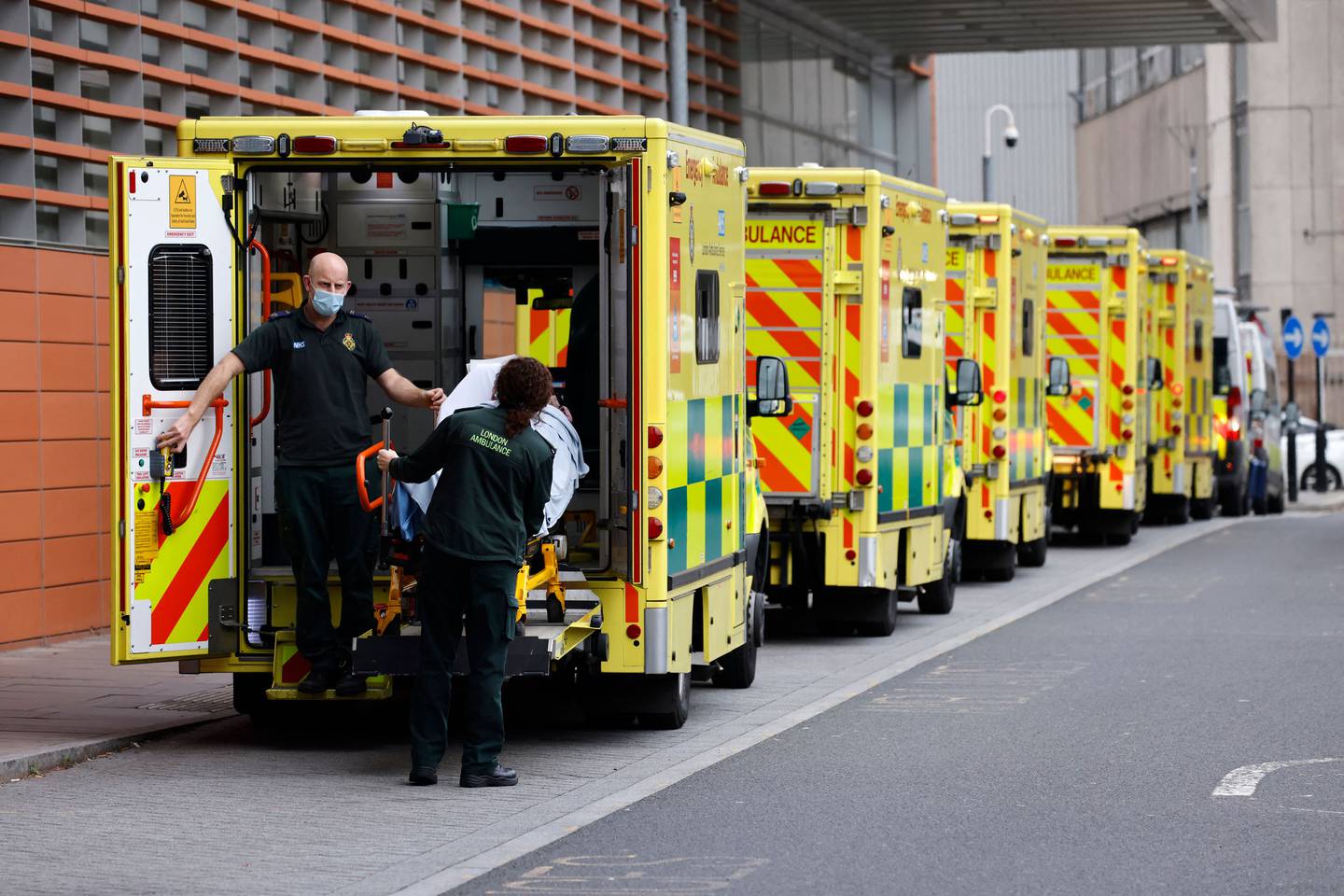 Paramedics unload a patient from an ambulance outside the Royal London hospital. AFP