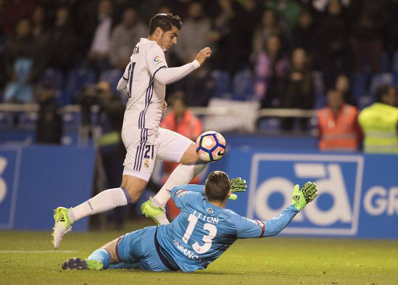 Real Madrid's Alvaro Morata fights for the ball with Deportivo goalkeeper Tyton. Lal R Villar / AP Photo