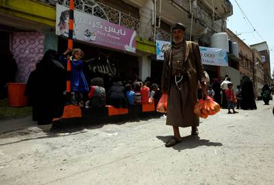 A Yemeni man leaves with his food aid. EPA