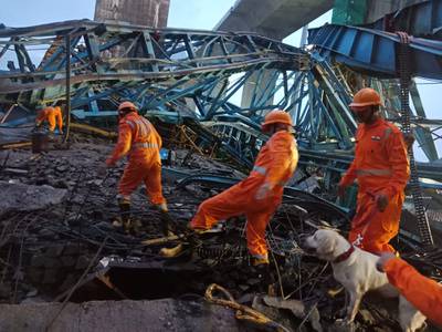 National Disaster Response Force personnel attempt to rescue construction workers believed to be trapped under a collapsed crane in Shahapur, India on Tuesday.  AP