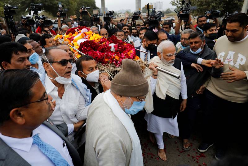 Indian Prime Minister Narendra Modi carries the body of his mother, Heeraben, at a crematorium in Gandhinagar, India. Reuters