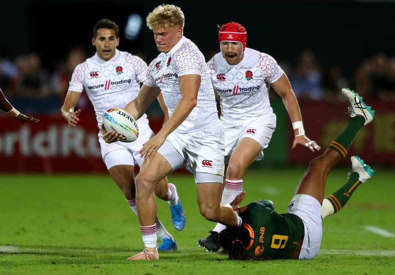 DUBAI, UNITED ARAB EMIRATES - DECEMBER 06: Ben Harris of England is tackled by Justin Geduld of South Africa during the match between England and South Africa on Day Two of the HSBC World Rugby Sevens Series - Dubai at The Sevens Stadium  on December 06, 2019 in Dubai, United Arab Emirates. (Photo by Francois Nel/Getty Images)