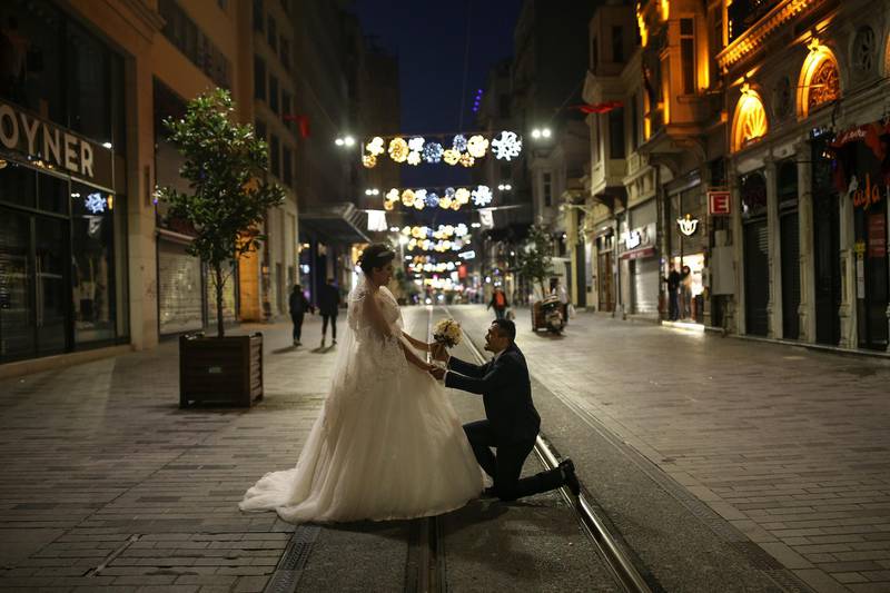 Newly-wed Yasemin Tuna and Murat Targut pose for their photographer in Istanbul's deserted Istiklal Street, the main shopping street of Turkey's biggest city. AP Photo