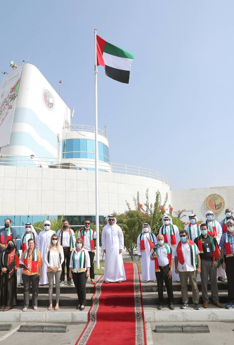 Sheikh Mohammed bin Sultan bin Khalifa raises the flag. WAM
