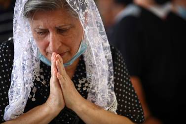 A woman attends a Sunday service at a church that was damaged following Tuesday's blast in Beirut's port area, Lebanon, August 9. Hannah McKay / Reuters