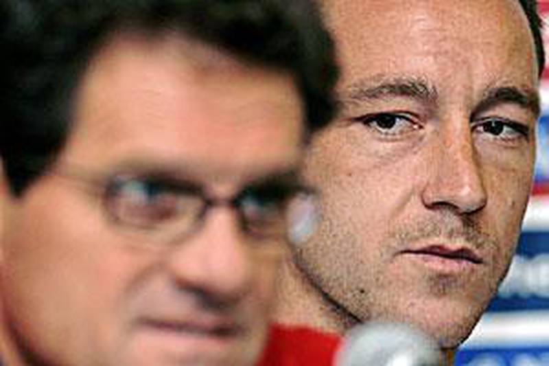 John Terry overlooks the shoulder of England coach Fabio Capello in this file photo.