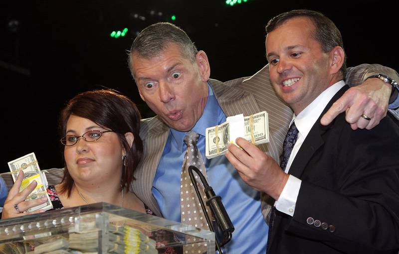Vince McMahon, centre, congratulates winners Sarah Furhman, left, and Steve Rosenzweig at the announcement of the first McMahon Million Dollar Mania Winners at the Hard Rock Cafe June 12, 2008 in New York City. Getty Images