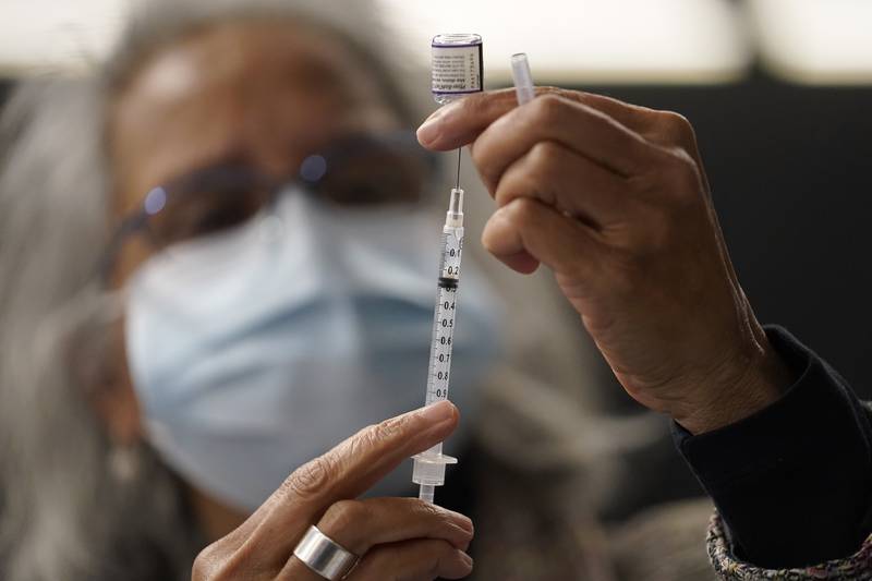 A vaccine dose is prepared in Massachusetts. AP