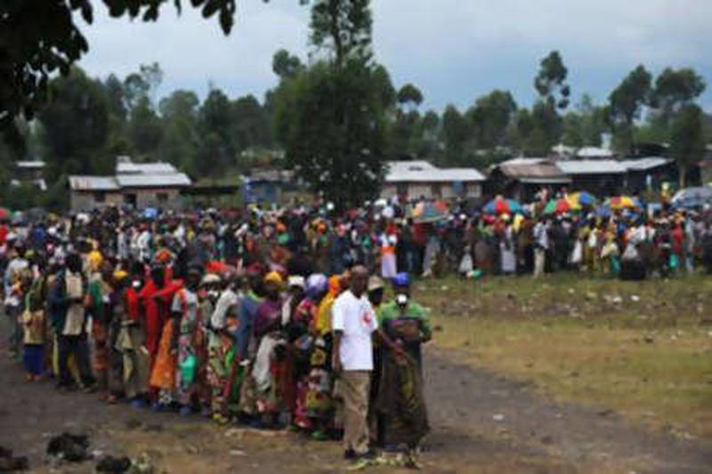 Hundreds of internally displaced people line up to receive food rations from the Congolese Red Cross near a camp for displaced people in Kibati.