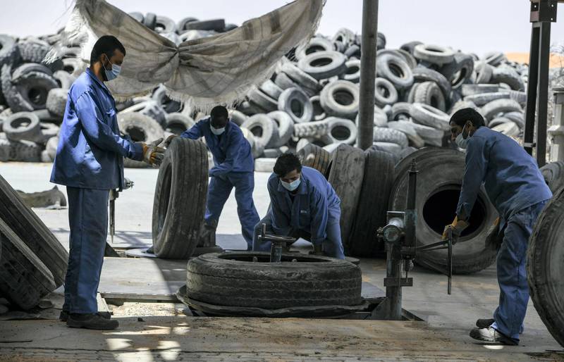 Abu Dhabi, United Arab Emirates - Workers prepare the tires before the recycling process at the Gulf Rubber factory in Al Ain. Khushnum Bhandari for The National