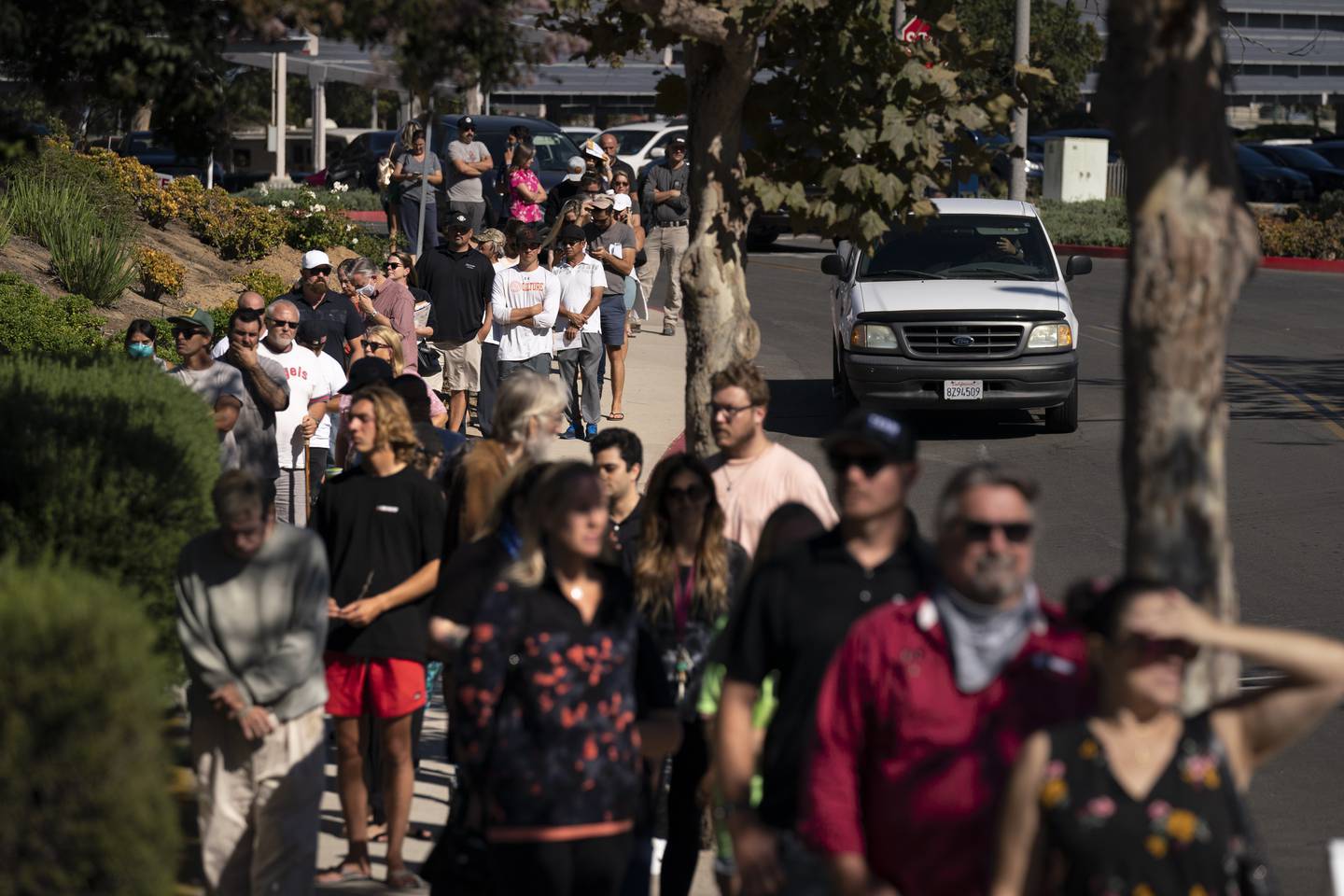 People wait in line to vote outside a polling location on September  14, 2021, in Huntington Beach, California, where President Joe Biden received 54 per cent of the vote. AP