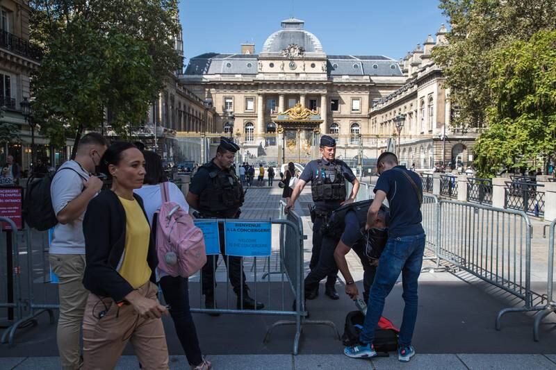 Policemen secure the access to the courthouse in Paris. EPA