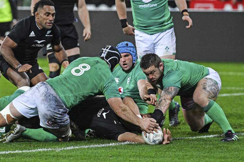 Ardie Savea of New Zealand scores a try as Caelan Doris, left, and Andrew Porter, right, of Ireland attempt a tackle. AP