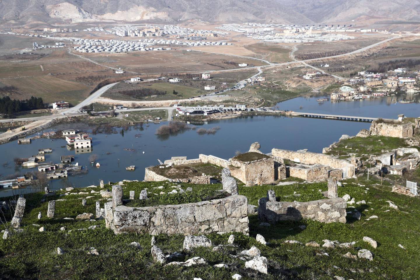 An old cemetery is seen in Hasankeyf, which will be significantly submerged by the Ilisu Dam, with new Hasankeyf in the background in southeastern Batman province, Turkey, February 20, 2020. Picture taken February 20, 2020. REUTERS/Murad Sezer