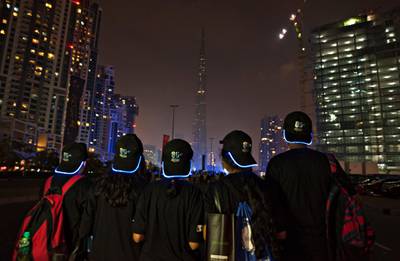 DUBAI, UNITED ARAB EMIRATES - March 28, 2015 - Members of 'Students for Earth, a non-profit organization view the Burj Khalifa during the Earth Hour walk around Bay Avenue Park in Business Bay, Dubai City, Dubai March 28, 2015  (Photo by Jeff Topping/For The National) *** Local Caption ***  na29mr-pg4-EarthHour.jpg