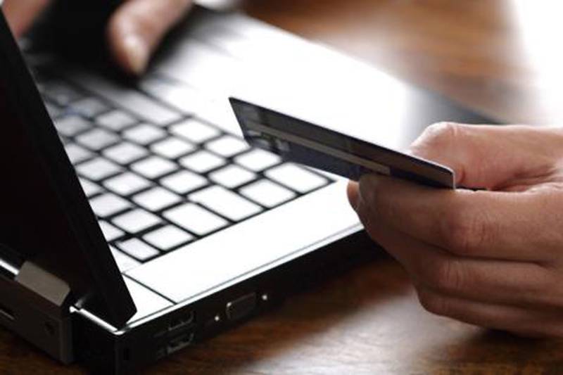 Person with credit card using a computer for internet shopping. istockphoto.com