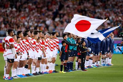 Japan's and Scotland's players line up prior to their Rugby World Cup Pool A game. AFP