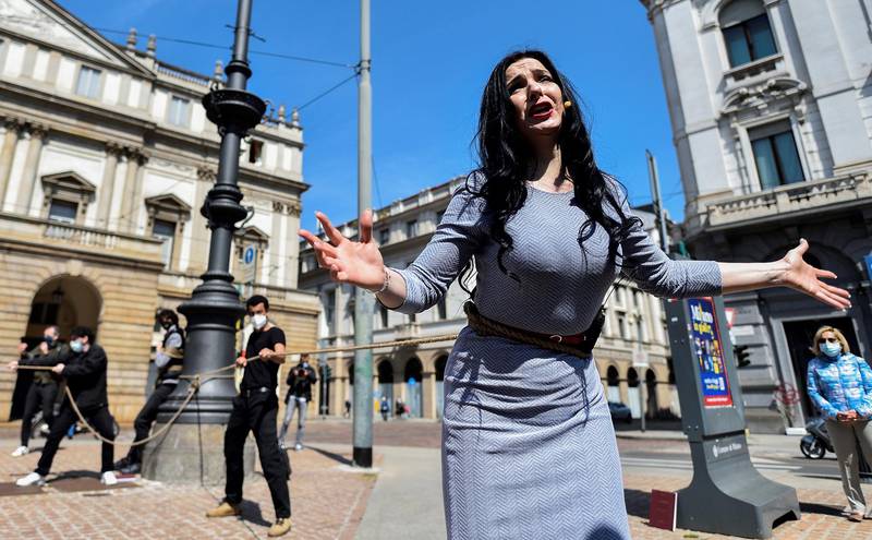 An opera singer performs the first act of Giacomo Puccini's famed romance opera 'La Boheme' outside the La Scala theatre as part of a protest against the entertainment sector's crisis caused by the pandemic, in Milan, Italy. Reuters