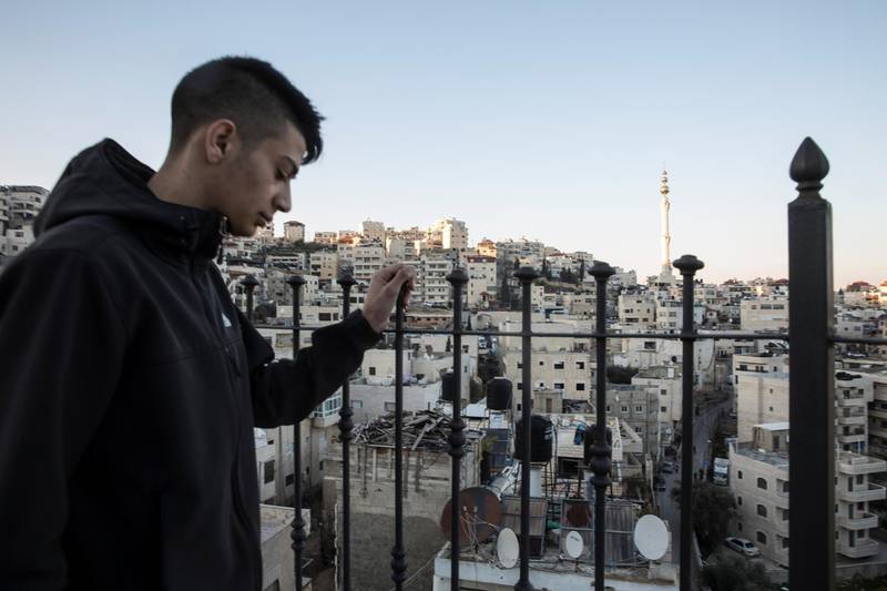 Palestinian Yehiya Derbas ,17,on the balcony of his home in  Issawiyah, a hardened and impoverished east Jerusalem neighborhood on March 9,2019.The day the Trump administration announced last December that it would be moving the United States Embassy to Jerusalem, Yehiya DerbasÕ life changed forever.  Derbas, then a slight 16-year-old, joined in Palestinian protests against the move. And like many young men before and after him, Derbas told The National that Israeli forces shot him and later imprisoned him for one year on charges related to the dayÕs violence.  

Upon his release in early February, now marked as an ex-con, Derbas returned to a city that in most ways has remained the same day-to-day Ñ but that intangibly has significantly changed. (Photo by Heidi Levine For The National).
