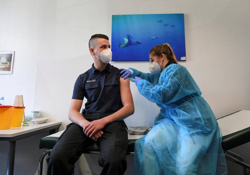 A German police staff member receives AstraZeneca's vaccine in Munich, Germany. Reuters