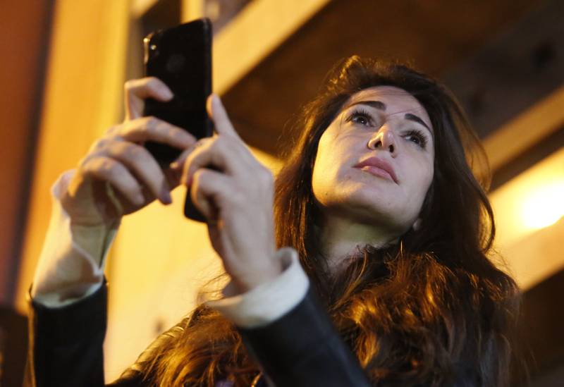 Dima Sadek films an anti-government protest in Beirut in 2019. One of her tweets has caused a backlash among supporters of Hezbollah and the Amal Movement. AP