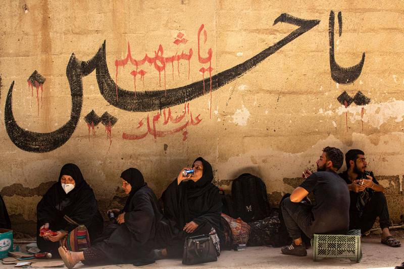 Iranian pilgrims sit waiting upon their arrival to Iraq via the Al Shalamija border crossing, west of the southern city of Basra, before starting their journey toward the holy city of Karbala. AFP