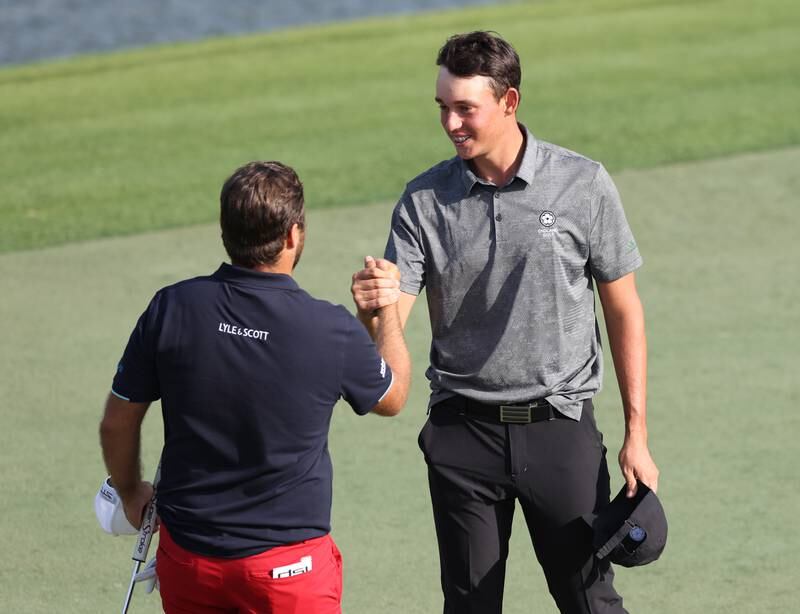 Romain Langasque of France shakes hands with Dubai-born teenager Josh Hill on the 18th hole. Getty